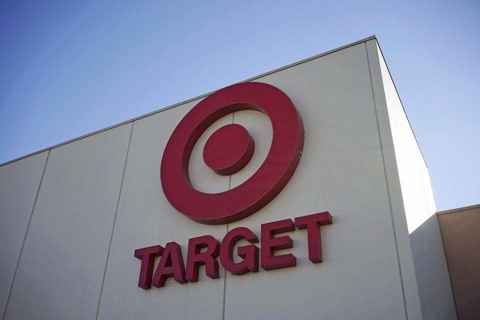 The sign outside the Target store is seen in Arvada, Colorado in this file photo taken January 10, 2014. Several analysts expect Target Corp to slash its share buybacks as the third-largest U.S. retailer copes with costs tied to the massive data breach that affected millions of customers. REUTERS/Rick Wilking/Files (UNITED STATES - Tags: BUSINESS LOGO)