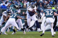 Tennessee Titans' Derrick Henry, center, runs with the ball during the second half of an NFL football game against the Philadelphia Eagles, Sunday, Dec. 4, 2022, in Philadelphia. (AP Photo/Matt Rourke)