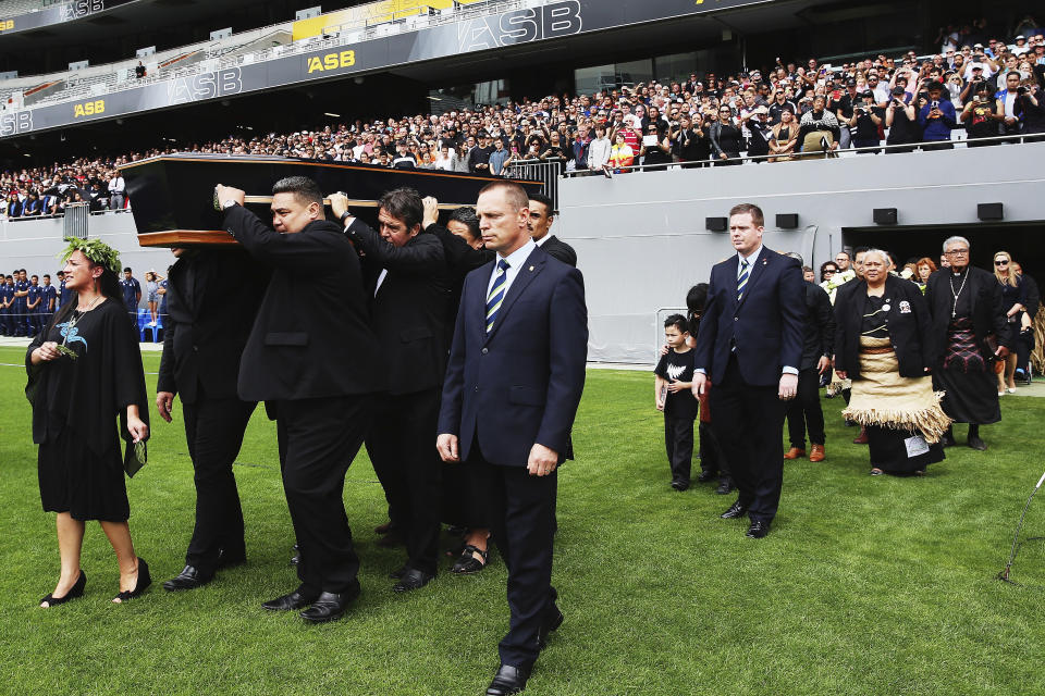 FILE - In this Nov. 30, 2015, file photo, the casket carrying the body of Jonah Lomu is carried onto the field during the public memorial for the former All Black at Eden Park in Auckland, New Zealand. One trampling run launched Jonah Lomu to global stardom and ensured his name will be indelibly linked to a Rugby World Cup semifinal between New Zealand and England. The All Blacks winger’s rampaging runs during that era-defining World Cup in South Africa in 1995 were highlighted by his four-try haul against England in the semifinals. New Zealand and England meet again in the semifinals this Saturday, Oct. 26, 2019, at Yokohama. (Hannah Peters/Pool Photo via AP, File)