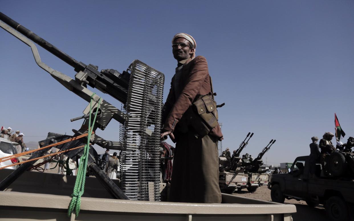 Yemen's Houthi fighter mans a heavy machine gun mounted on a vehicle at a rally in support of Palestinians in the Gaza Strip