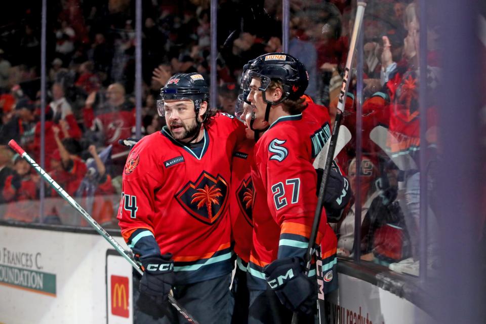 Coachella Valley Firebirds celebrate a first period score by forward Cameron Hughes (19) at Acrisure Arena in Palm Desert, Calif., on Sunday, Feb. 18, 2024.