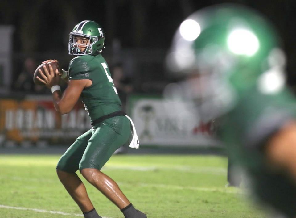 Venice High quarterback Jadyn Glasser (5) spots an open receiver downfield during the FHSAA Kickoff Classic game against Tampa Bay Tech at Venice High School.