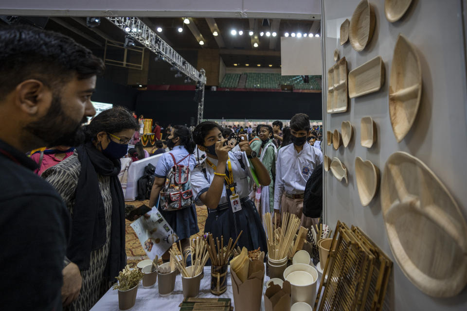 People visit a stall at an event to create awareness about eco-friendly products in New Delhi, India, Friday, July 1, 2022. India banned some single-use or disposable plastic products Friday as part of a federal plan to phase out the ubiquitous material in the nation of nearly 1.4 billion people. (AP Photo/Altaf Qadri)