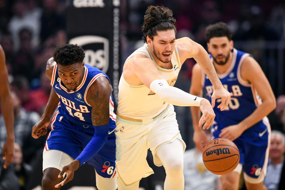 Cleveland Cavaliers forward Cedi Osman, right, steals the ball from Philadelphia 76ers forward Paul Reed during the first half of an NBA basketball game, Wednesday, Nov. 30, 2022, in Cleveland. (AP Photo/Nick Cammett)