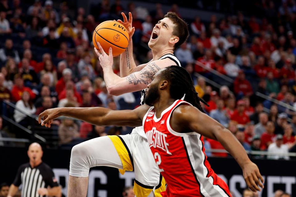 MINNEAPOLIS, MINNESOTA - MARCH 14: Patrick McCaffery #22 of the Iowa Hawkeyes draws a foul against Bruce Thornton #2 of the Ohio State Buckeyes in the first half in the Second Round of the Big Ten Tournament at Target Center on March 14, 2024 in Minneapolis, Minnesota. (Photo by David Berding/Getty Images)