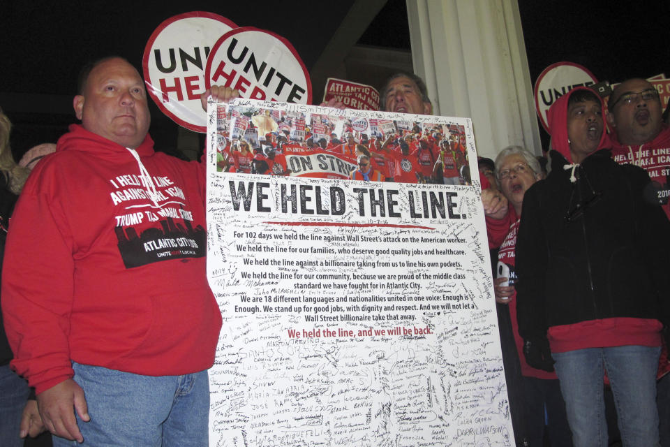 FILE - Striking union members holding a poster they signed on Oct, 10, 2016 moments after the Trump Taj Mahal closed in Atlantic City, N.J. Bob McDevitt is stepping down as president of the main Atlantic City casino workers union, Local 54 of Unite Here, after 26 years as one of the most powerful people in Atlantic City. On May 1, 2023, he'll become head of the union's national pension plan. (AP Photo/Wayne Parry)