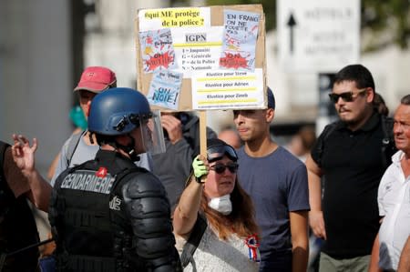 A protester holds a banner in front of a french gendarme during a demonstration on Act 44 (the 44th consecutive national protest on Saturday) of the yellow vests movement in Nantes