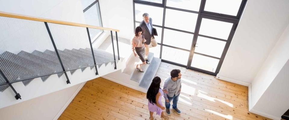 Real estate agent showing new house to couple