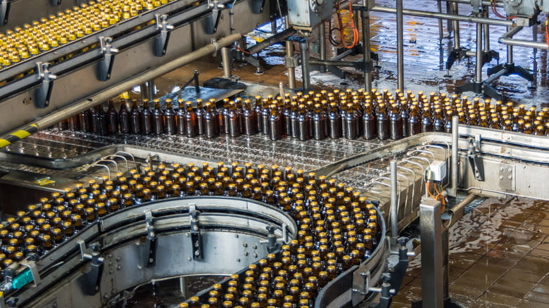 XXXX bottles on assembly line
