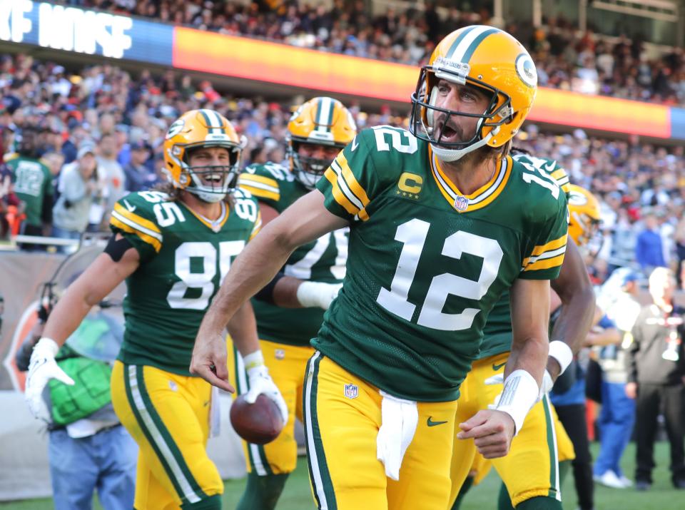 Green Bay Packers quarterback Aaron Rodgers (12) celebrates his rushing touchdown during the fourth quarter of the Green Bay Packers 24-14 win at Soldier Field in Chicago on Sunday, Oct. 17, 2021.