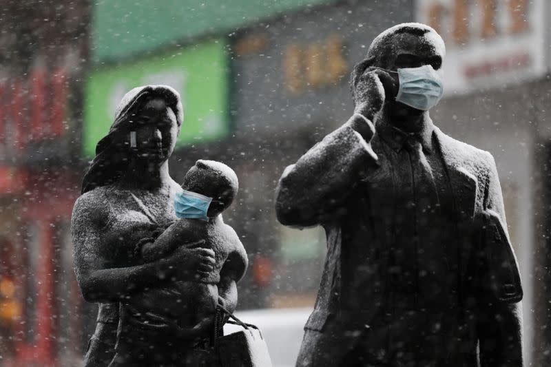 Statues with face masks on are seen amid snow in Wuhan, the epicentre of the novel coronavirus outbreak