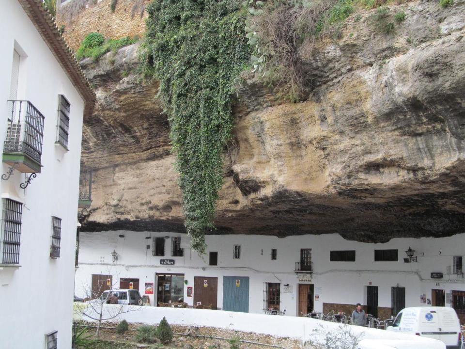 This Jan. 17, 2013 photo shows the narrow road of Setenil de las Bodegas. Many of the houses and stores in this Spanish "pueblo blanco," or white village, are carved into river-eroded rock. (AP Photo/Giovanna Dell’Orto)