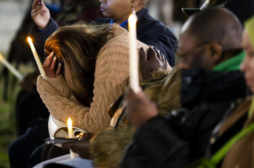 Donna Bruce holds her hand in her hands and cries during during a vigil for the homicide victims of 2023 on Wednesday, Jan. 3, 2023 in Baltimore. Mayor Brandon Scott hosted the vigil. (Kaitlin Newman /The Baltimore Banner via AP)