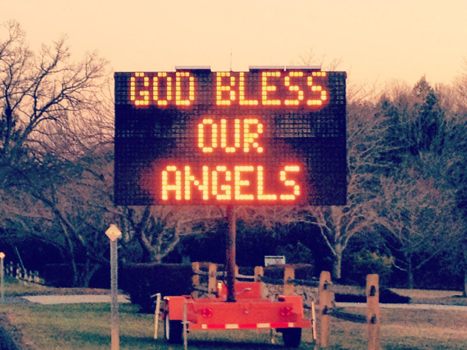 A roadside sign seen at dusk in Newtown, Conn., reads: Gold bless our angels.