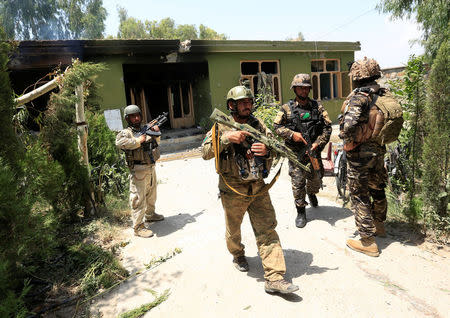 Afghan security forces personnel inspect a site after an attack in Jalalabad city, Afghanistan July 11, 2018. REUTERS/Parwiz