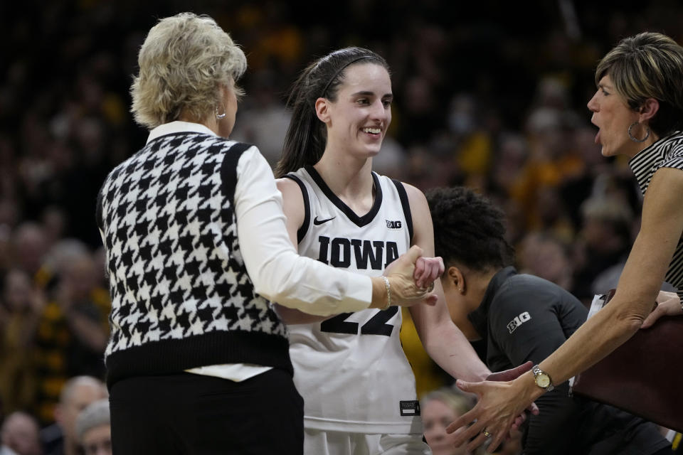 Iowa coach Lisa Bluder and associate head coach Jan Jensen congratulate Iowa guard Caitlin Clark (22) during the second half of the team's NCAA college basketball game against Michigan, Thursday, Feb. 15, 2024, in Iowa City, Iowa. (AP Photo/Matthew Putney)