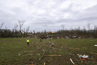 Volunteers comb through an area that was heavily damage by a tornado in Sullivan, Ind., Saturday, April 1, 2023, as search-and-rescue efforts continue. Storms that spawned possibly dozens of tornadoes have killed several people in the South and Midwest. (AP Photo/Doug McSchooler)