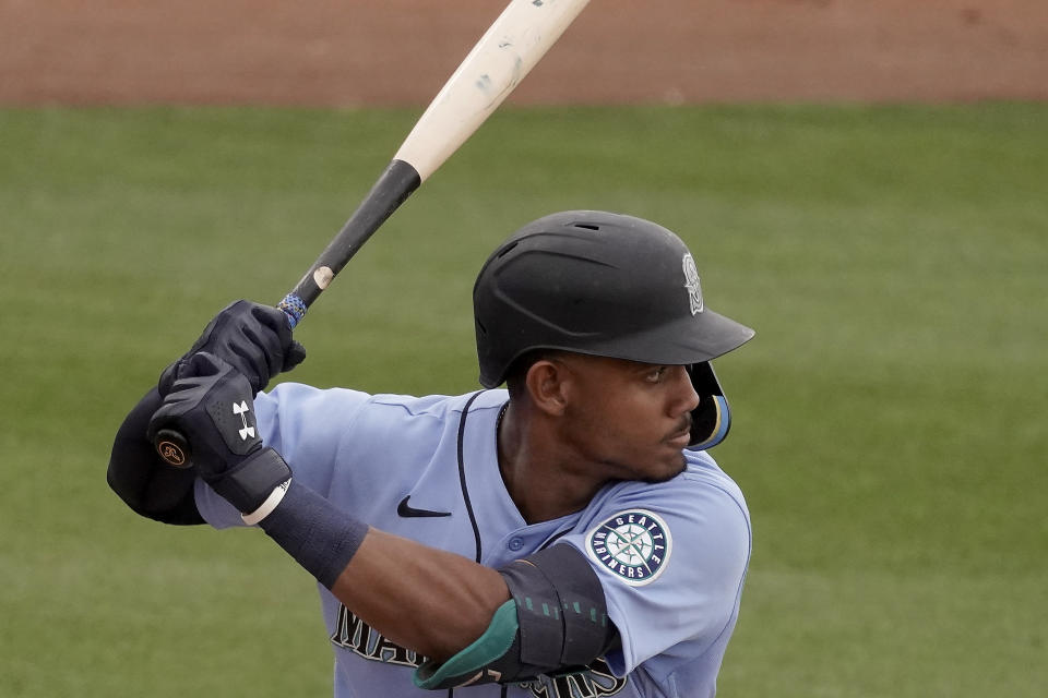 Seattle Mariners' Julio Rodriguez bats during the second inning of a spring training baseball game against the Texas Rangers Monday, March 28, 2022, in Peoria, Ariz. (AP Photo/Charlie Riedel)