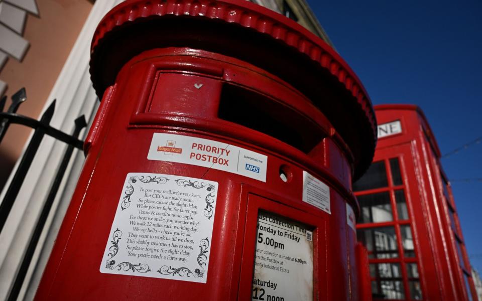 Royal Mail postal worker strikes has sparked poet and urban artist Bod to write a poem and paste on UK post boxes in support of the strike seen here in Weymouth England - Finnbarr Webster/Getty Images Europe