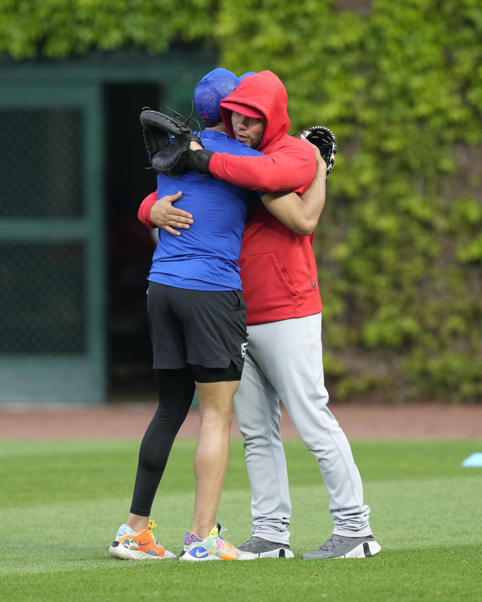 St. Louis Cardinals' Willson Contreras, right, hugs former teammate Christopher Morel, who was just called up by the Chicago Cubs, before a baseball game Monday, May 8, 2023, in Chicago, Contreras returned to Wrigley Field for the first time since leaving the Cubs after last season. (AP Photo/Charles Rex Arbogast)