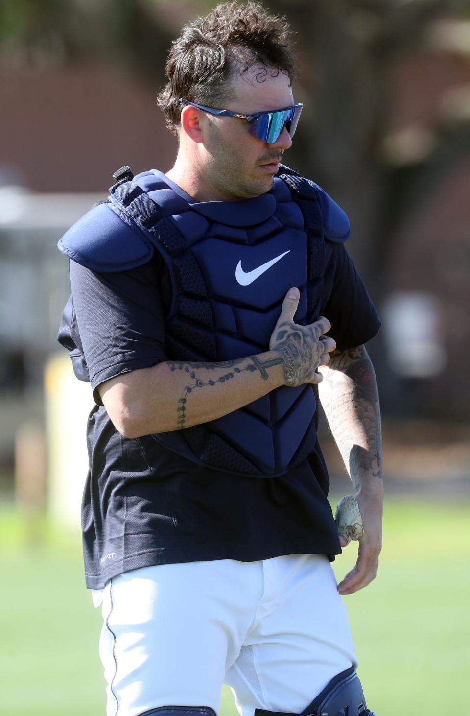 Tigers catcher Donny Sands puts on his equipment during spring training on Saturday, Feb. 18, 2023, in Lakeland, Florida.