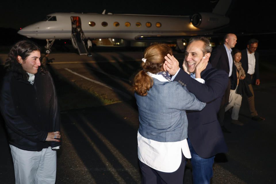 Family members embrace freed American Emad Shargi after he and four fellow detainees were released in a prisoner swap deal between U.S and Iran, as he arrives at Davison Army Airfield, Tuesday, Sept. 19, 2023 at Fort Belvoir, Va. (Jonathan Ernst/Pool via AP)