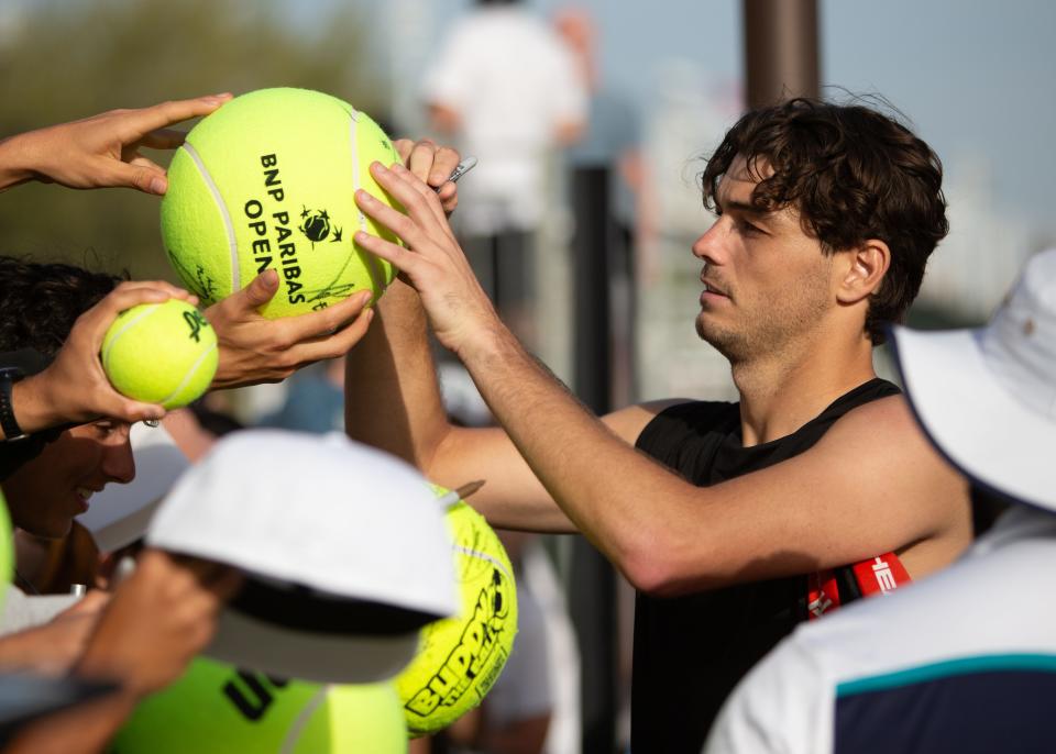 Taylor Fritz signs autographs for eager fans at the BNP Paribas Open tournament at Indian Wells Tennis Garden on March 4, 2024.