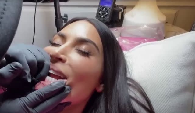 <p>Hulu/The Kardashians</p> Kim Kardashian gets lip tattoo