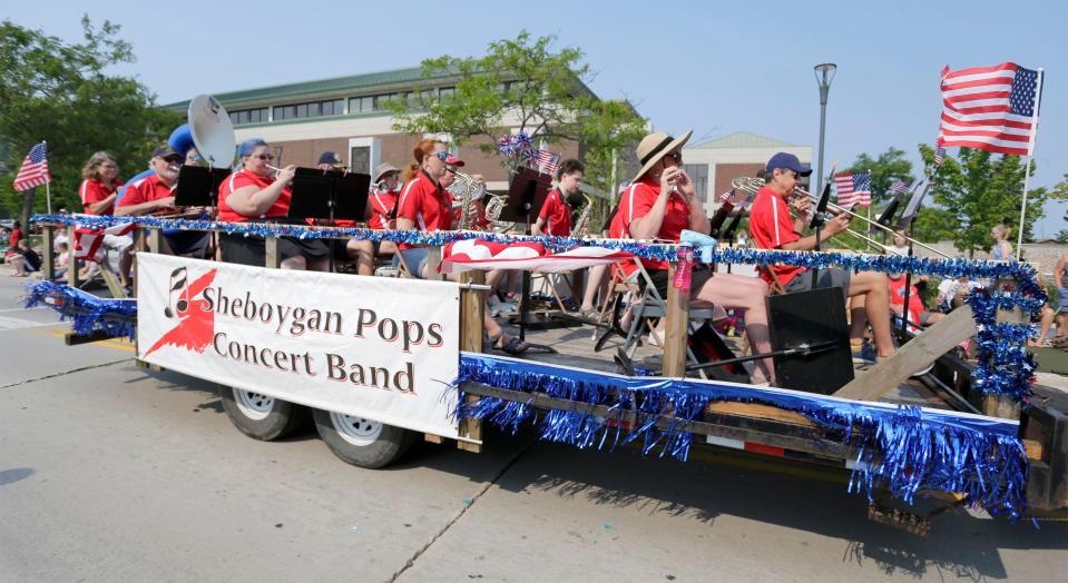 The Sheboygan Pops Band performs from a trailer at the Independence Day Celebration parade, Saturday, July 3, 2021, in Sheboygan, Wis.