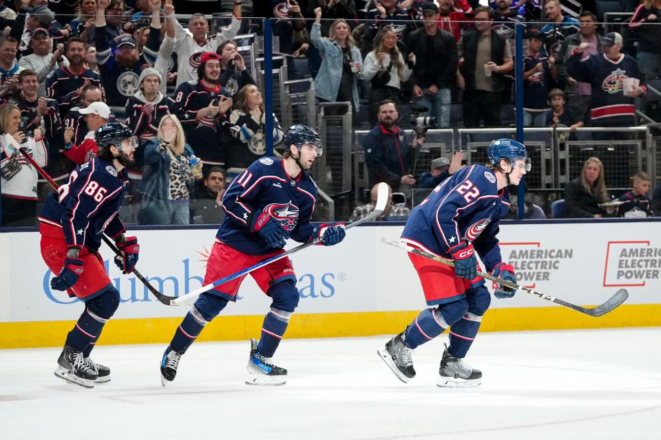 Oct 12, 2023; Columbus, Ohio, USA; Columbus Blue Jackets defenseman Jake Bean (22) celebrates a goal with center Adam Fantilli (11) and left wing Kirill Marchenko (86), who both were credited with assists, during the first period of the NHL hockey game at Nationwide Arena.
