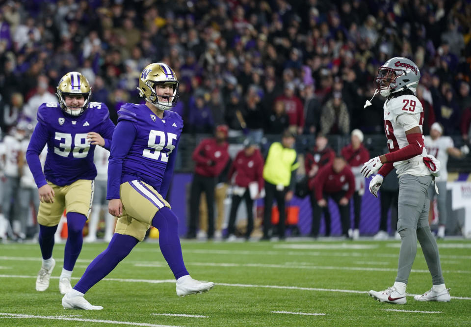 Washington place-kicker Grady Gross celebrates with punter Jack McCallister (38) after kicking the game-winning field goal as Washington State defensive back Jamorri Colson (29) looks on during the second half of an NCAA college football game Saturday, Nov. 25, 2023, in Seattle. (AP Photo/Lindsey Wasson)