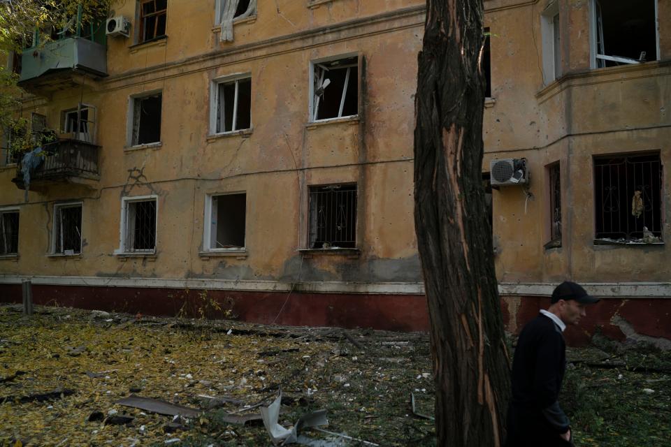 A man walks past a damaged building after a Russian attack in Kramatorsk, Ukraine, Thursday, Sept. 29, 2022.