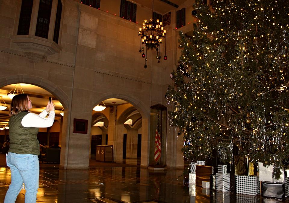 A Purdue Memorial Union visitor snaps a photo of the giant Christmas tree located in the Great Hall. The tree will remain up through Dec. 26.