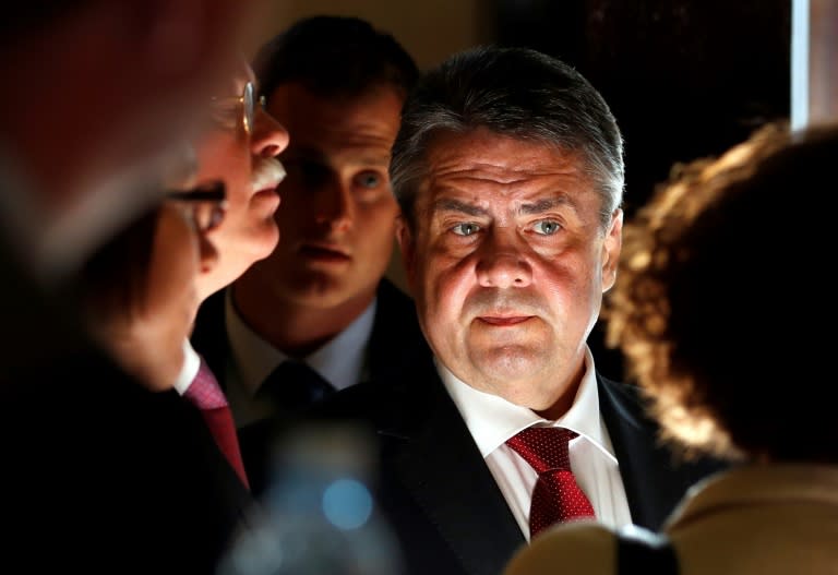 German Foreign Minister Sigmar Gabriel speaks with his staff before giving a press conference in Jerusalem on April 25, 2017