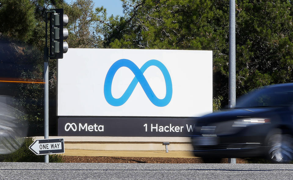 FILE - A car passes Facebook's new Meta logo on a sign at the company headquarters on Oct. 28, 2021, in Menlo Park, Calif. The latest folding smartphones, immersive metaverse experiences, AI-powered chatbot avatars and other eye-catching technology are set to wow visitors at the annual MWC wireless trade fair. The four-day show, also known as Mobile World Congress, kicks off Monday in a vast Barcelona conference center. It's the world’s biggest and most influential meeting for the mobile tech industry. (AP Photo/Tony Avelar, File)