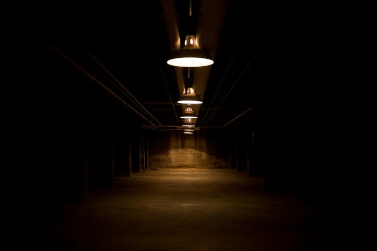 Dimly lit by a series of hanging industrial lamps, the concrete room houses rows of barrels marked "survival supplies": water, medicines, food rations and Civil Defense instruction manuals