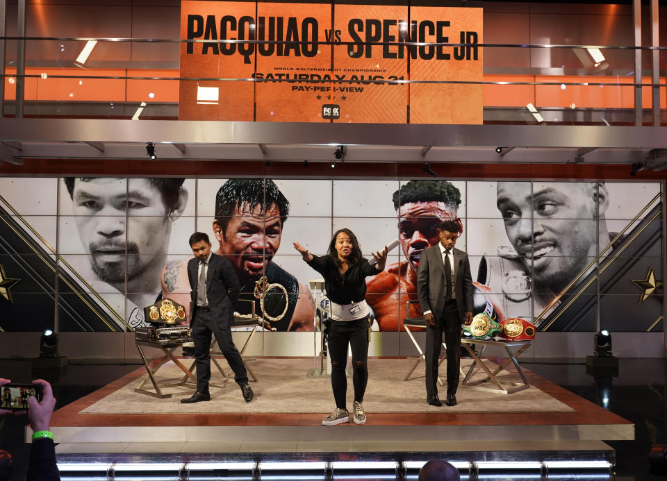 Fox Sports stage manager Carrie Snow, middle, directs the start of a live broadcast of a news conference with boxers Manny Pacquiao, left, and Errol Spence Jr., at the Fox Studios lot in Los Angeles, Sunday, July 11, 2021. (AP Photo/Damian Dovarganes)