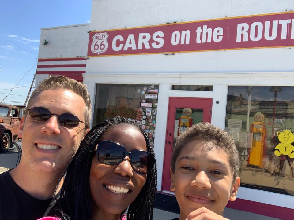 From left to right, Brennen Matthews and his wife Kate Matthews and son Thembi Matthews take a selfie outside of Cars on the Route, a Route 66 attraction in Kansas. Brennen is the author of "Miles to Go: An African Family in Search of America Along Route 66." The book document's the family's travels along Route 66 from Chicago to Los Angeles.