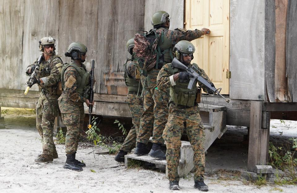 Soldiers from a multinational force perform assault maneuvers while participating in joint military exercises with troops from the United States Southern Command at Camp Stephenson in Timehri, Guyana, on July 26, 2023. <em>Photo by KENO GEORGE/AFP via Getty Images</em>