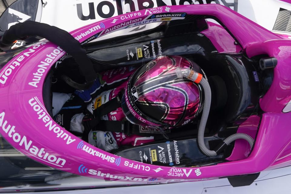 Helio Castroneves, of Brazil, sits in his car during practice for the IndyCar Grand Prix auto race at Indianapolis Motor Speedway, Friday, May 12, 2023, in Indianapolis. (AP Photo/Darron Cummings)