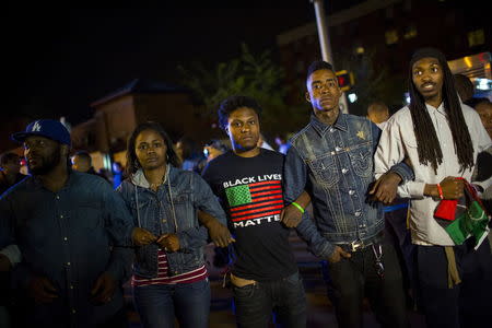 Protestors line up shortly before the deadline for a city-wide curfew at North Ave and Pennsylvania Ave in Baltimore, Maryland April 30, 2015. REUTERS/Eric Thayer