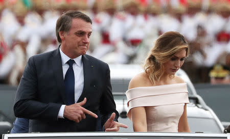 Brazil's new President Jair Bolsonaro gestures as he drives past before his swear-in ceremony, in Brasilia, Brazil January 1, 2019. REUTERS/Ricardo Moraes