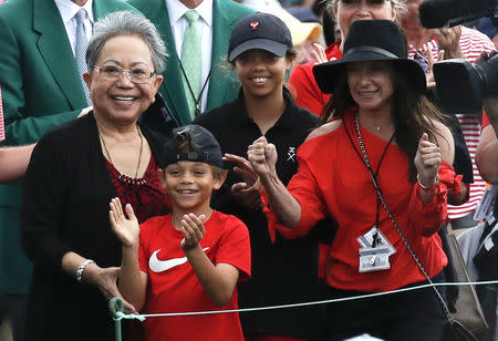 Golf - Masters - Augusta National Golf Club - Augusta, Georgia, U.S. - April 14, 2019 - Tiger Woods' family, daughter Sam Alexis, son Charlie Axel, mother Kultida woods (L) and girlfriend Erica Herman, smile has he approaches them after he won the 2019 Masters. REUTERS/Mike Segar