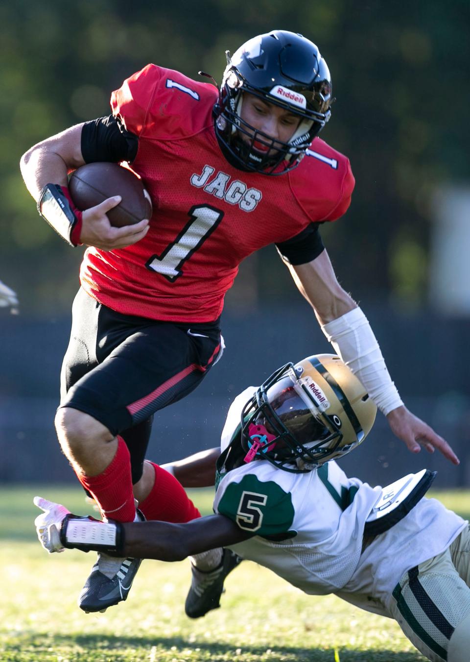 Jackson Memorial’s Tai Mann gains yards while running through Brick Memorial’s Jasaan Whitaker.  Brick Memorial at Jackson Memorial football. Jackson, NJThursday, September 1, 2022