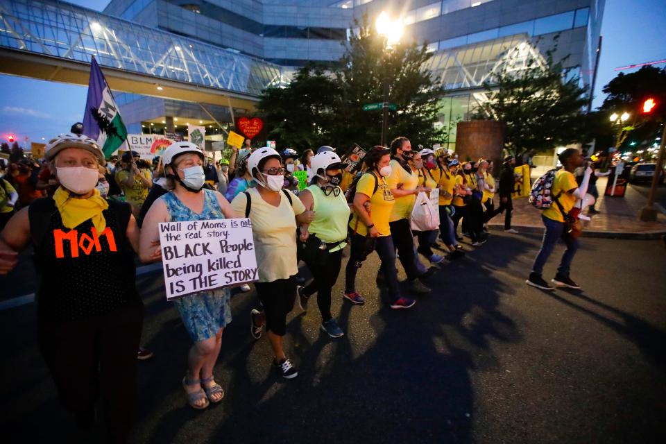 In this July 29, 2020, file photo, members of the "Wall of Moms" protest group march during a Black Lives Matter protest in Portland, Ore.