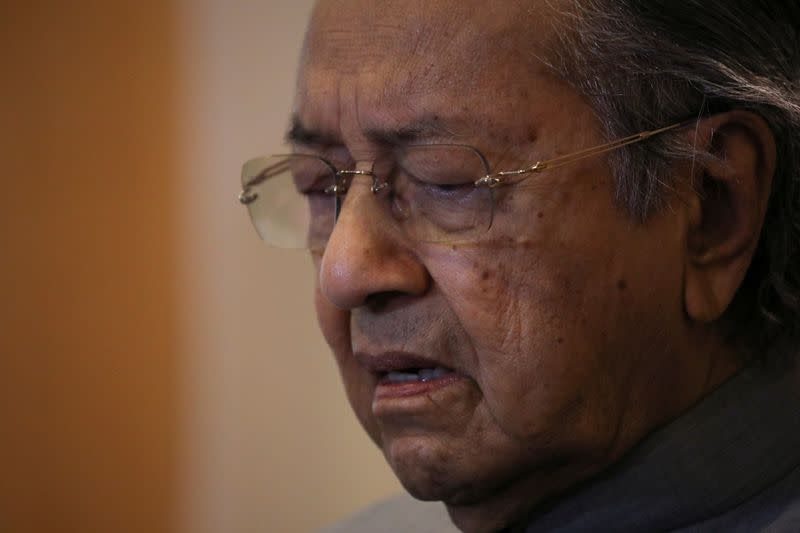 Malaysia's former Prime Minister Mahathir Mohamad reacts during a news conference in Putrajaya