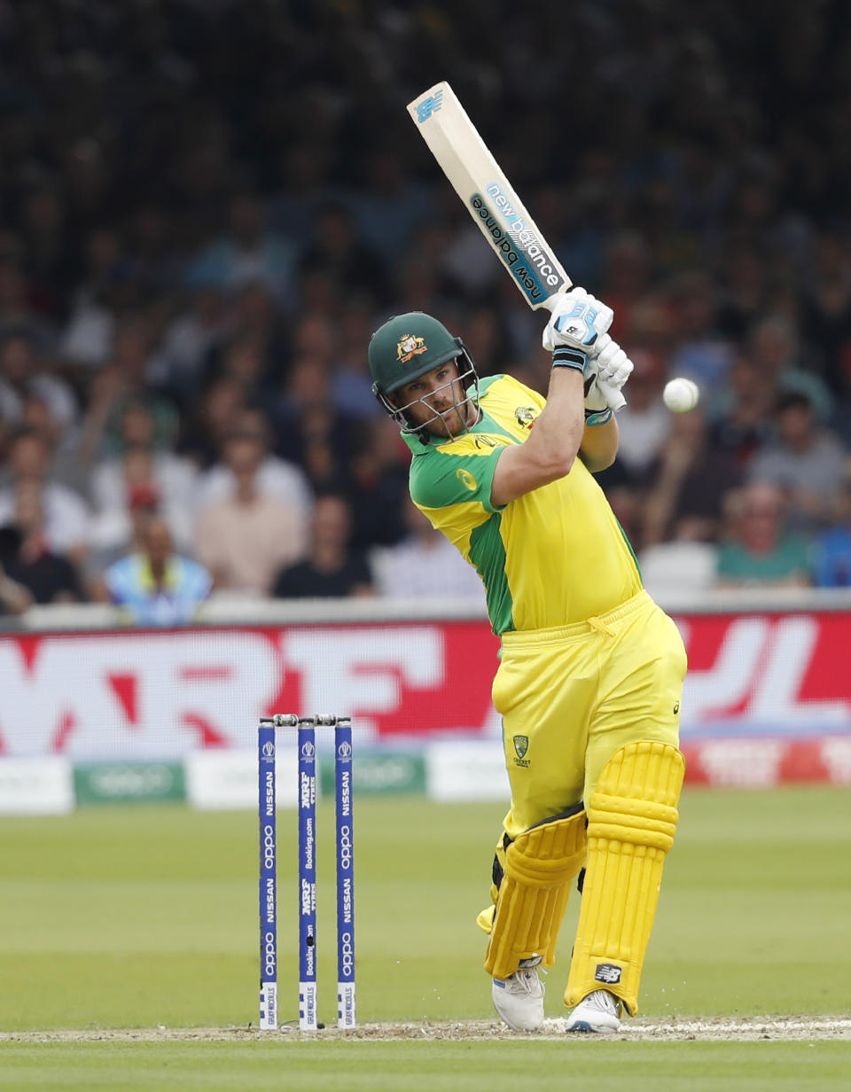 Australia's captain Aaron Finch hits runs off the bowling of England's Mark Wood during their Cricket World Cup match between England and Australia at Lord's cricket ground in London, Tuesday, June 25, 2019. (AP Photo/Alastair Grant)