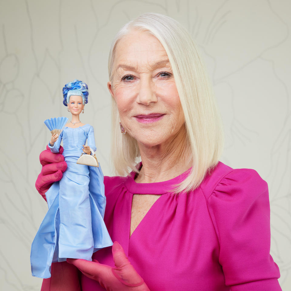 Dame Helen Mirren holding her one-of-a-kind Barbie. / Credit: Ryan Schude