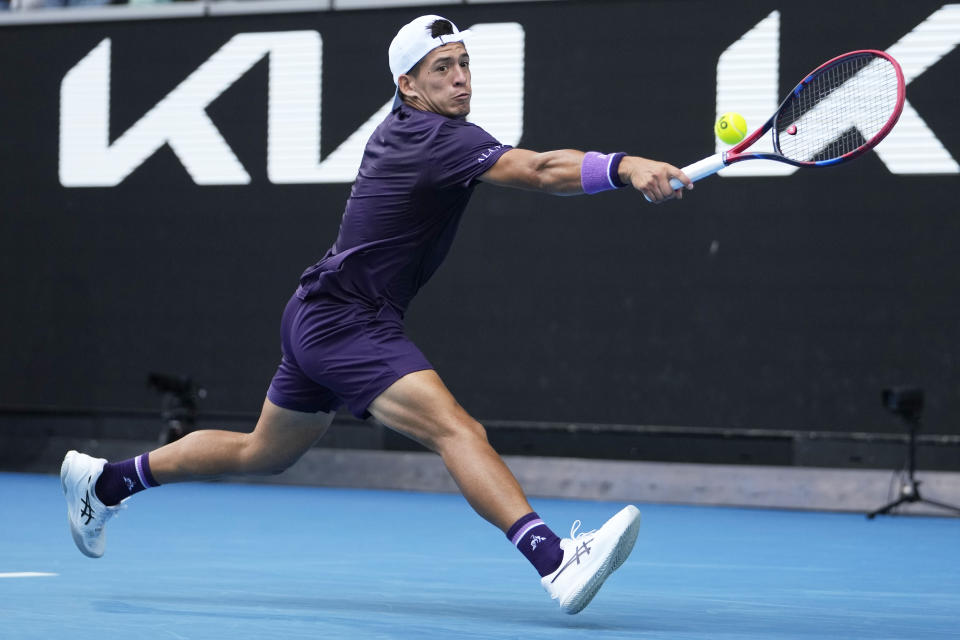 Sebastian Baez of Argentina plays a backhand return to Jannik Sinner of Italy during their third round match at the Australian Open tennis championships at Melbourne Park, Melbourne, Australia, Friday, Jan. 19, 2024. (AP Photo/Andy Wong)