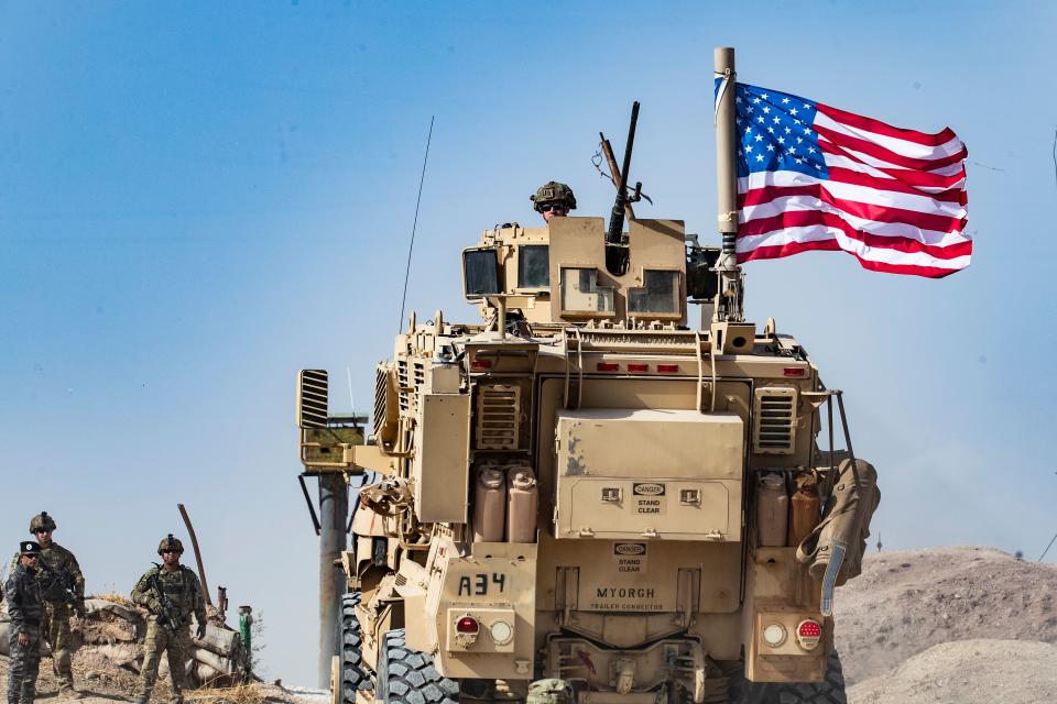 A U.S. soldier sits atop an armored vehicle during a demonstration by Syrian Kurds against Turkish threats at a U.S.-led international coalition base on the outskirts of Ras al-Ain town in Syria's Hasakeh province near the Turkish border, Oct. 6, 2019. (Photo: Delil Souleiman/AFP/Getty Images)
